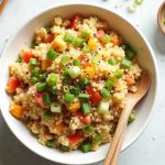 Classic keto cauliflower fried rice with eggs, vegetables, and green onions in a bowl