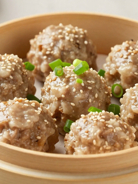 Steamed keto pork and shrimp dim sum meatballs in a bamboo steamer