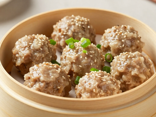Steamed keto pork and shrimp dim sum meatballs in a bamboo steamer